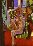 nude sitting in an armchair.