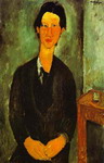 portrait of chaim soutine seated at a table.