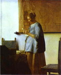 woman in blue reading a letter.